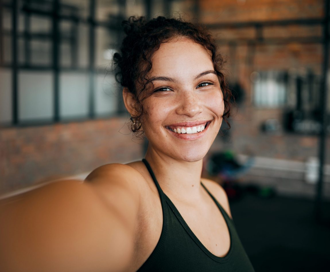 Fitness, exercise and gym selfie portrait of a woman happy about workout, training motivation and body wellness. Young sports female or athlete with a smile for blog inspiration and progress post Fitness, exercise and gym selfie portrait of a woman happy about workout, training motivation and body wellness. Young sports female or athlete with a smile for blog inspiration and progress post.